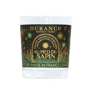 Petite bougie parfumée au pied du sapin