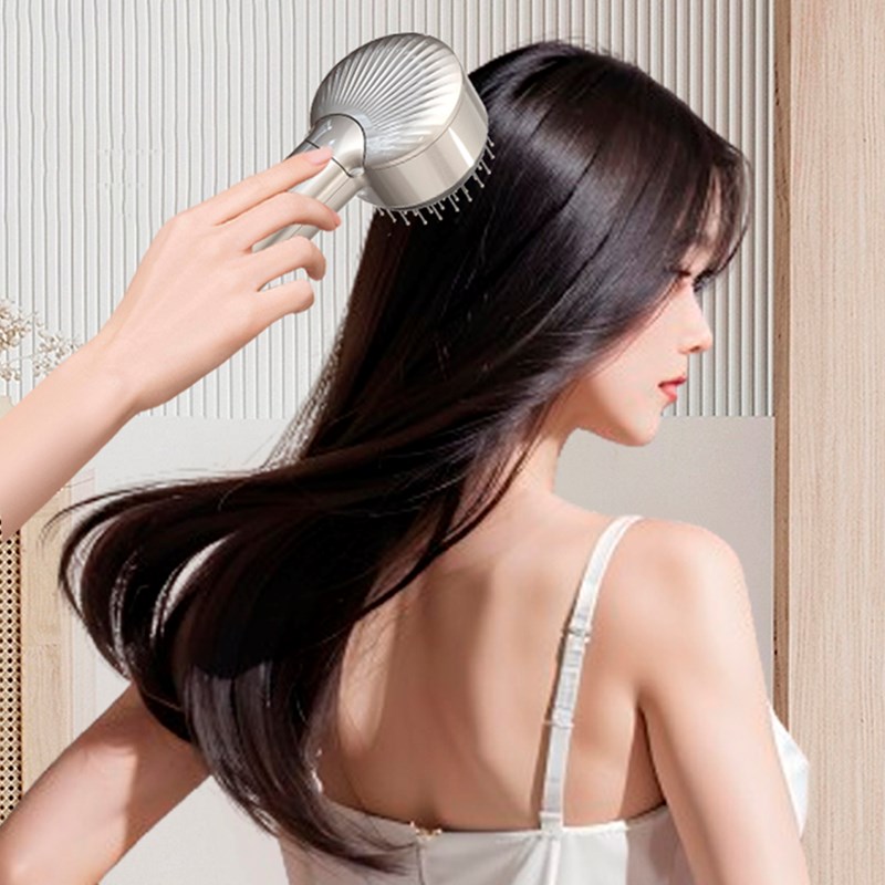 Peigne atomiseur avec massage à deux vitesses et base.