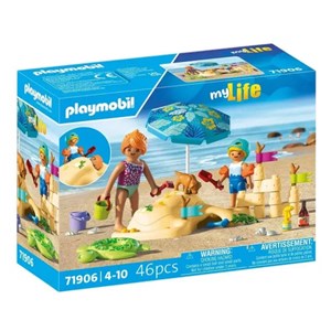 Famille jouant dans le sable à plage